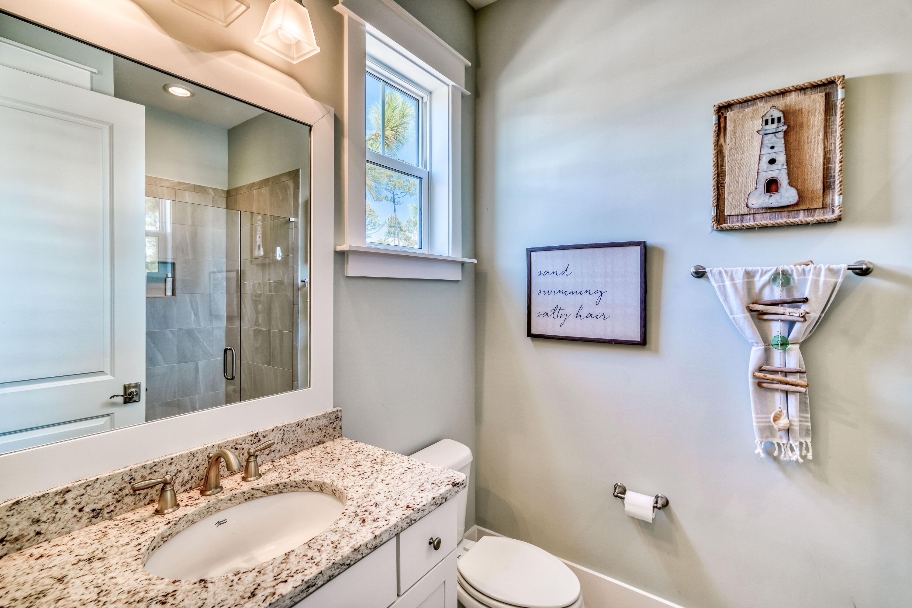 117 Prairie Pass Santa Rosa Beach, FL 32459 - Photo 11 of 26 a bathroom with a granite countertop sink mirror vanity and toilet