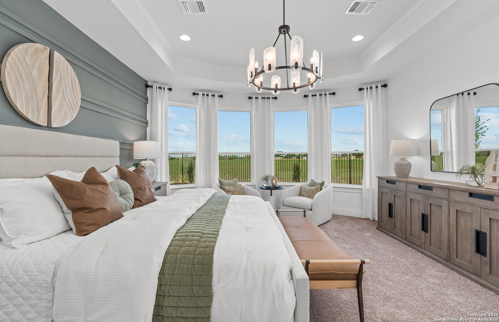 205 Farming Grove Boerne, TX 78006 - Photo 23 of 27 a spacious bedroom with a large bed and a chandelier