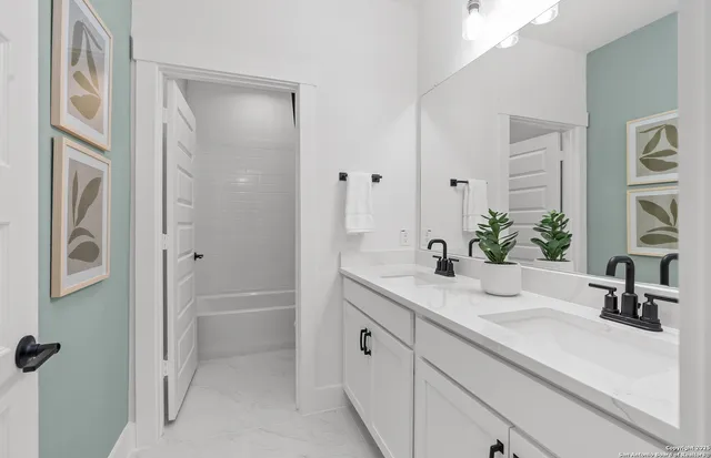a bathroom with a tub sink and mirror