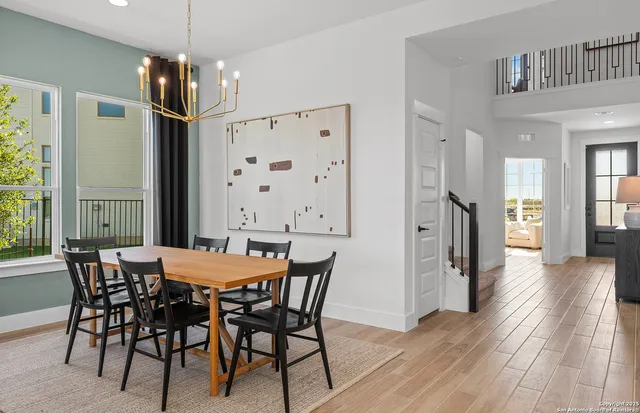 a dining room with furniture window and wooden floor