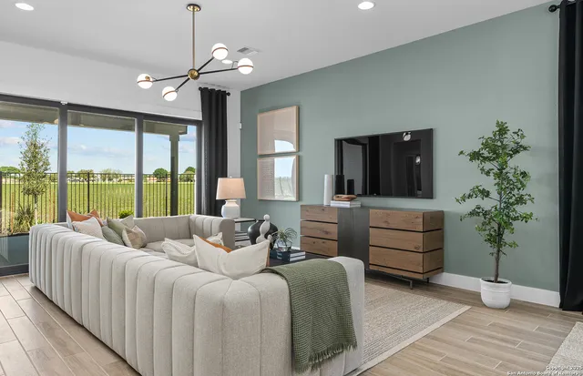 a living room with furniture and a large window