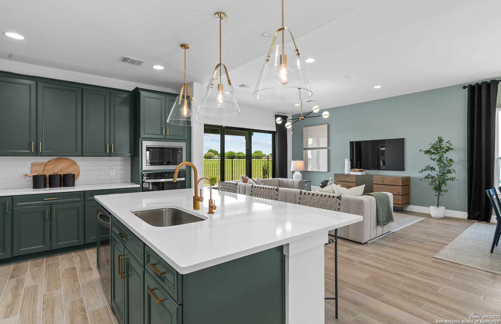 205 Farming Grove Boerne, TX 78006 - Photo 10 of 27 a kitchen with stainless steel appliances granite countertop a sink a stove and a wooden floors