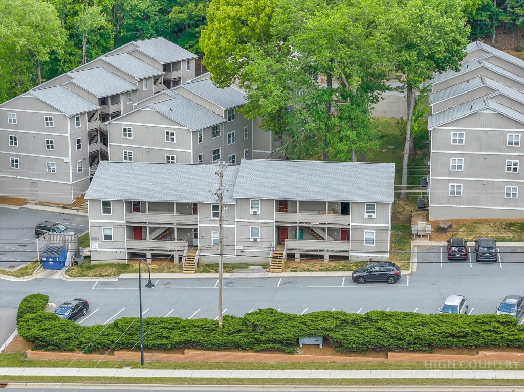 229 East King Street, Unit 30 Boone, NC 28607 - Photo 4 of 19 a front view of a building with a garden and plants