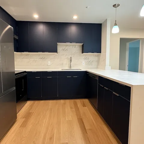 a kitchen with a sink and a refrigerator