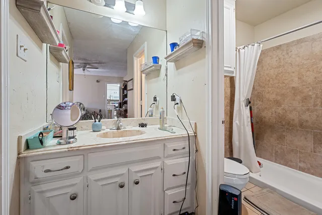 a bathroom with a double vanity sink mirror and shower