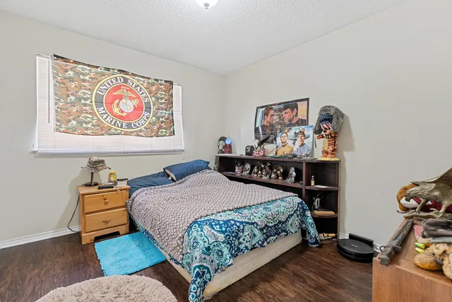 a bedroom with a bed and dresser