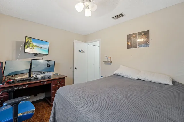 a bedroom with a bed and a desk