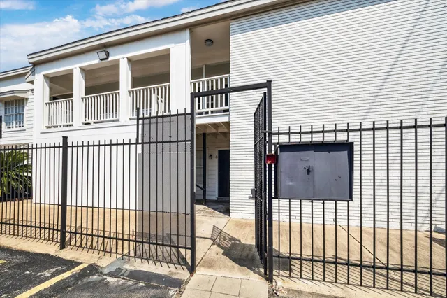 a view of a house with a wooden fence
