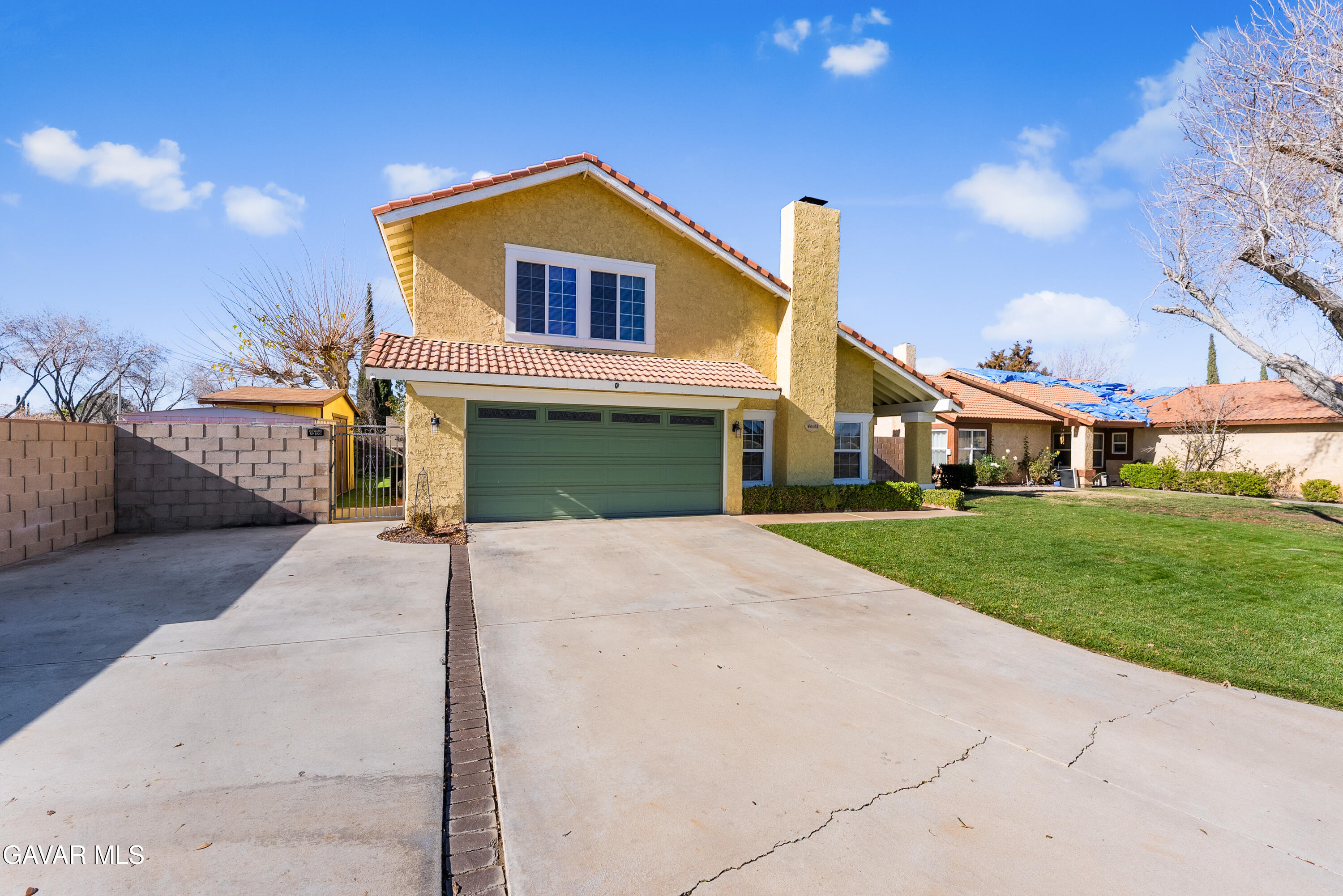 44003 7th Street East Lancaster, CA 93535 - Photo 16 of 62 a front view of a house with a yard and garage