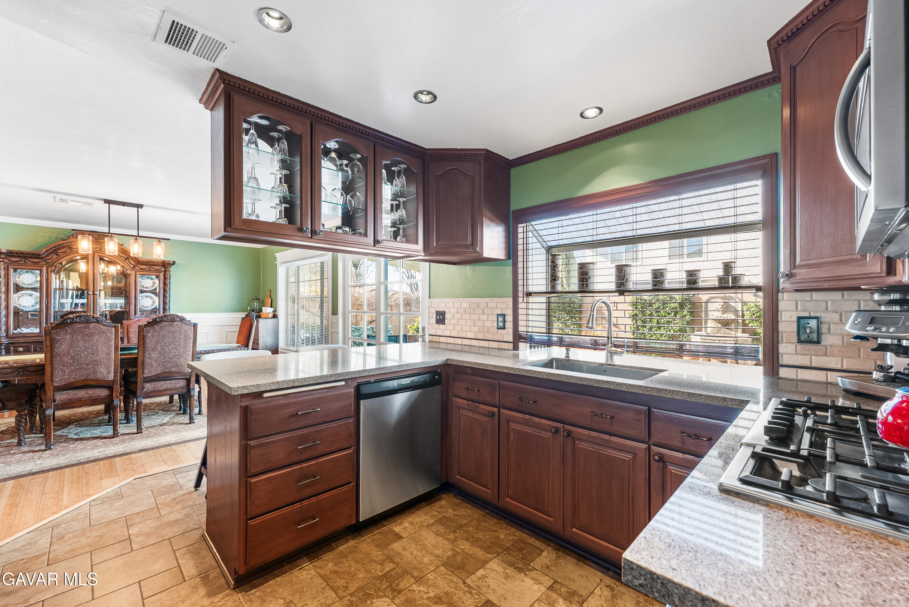 44003 7th Street East Lancaster, CA 93535 - Photo 41 of 62 a kitchen with stainless steel appliances kitchen island granite countertop a sink and cabinets
