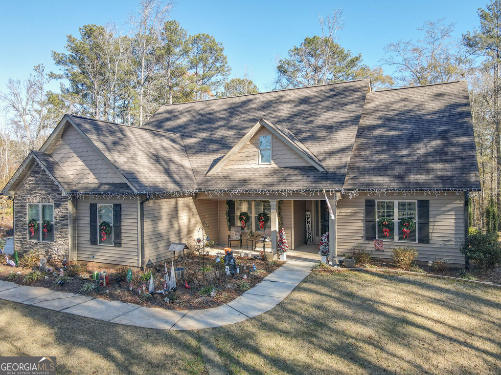 152 Moody Farm Road Newnan, GA 30263 - Photo 1 of 1 a view of a patio with table and chairs under an umbrella