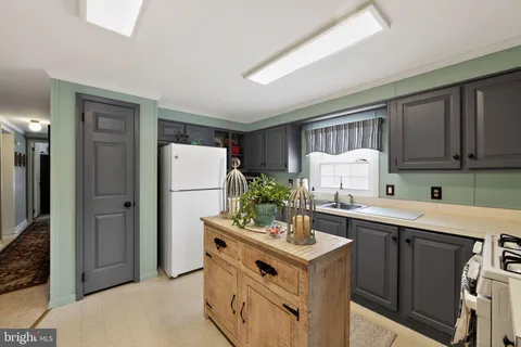 a kitchen with a sink stove and refrigerator