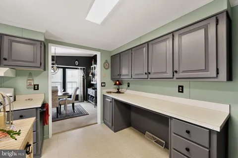 a kitchen with a sink cabinets and window