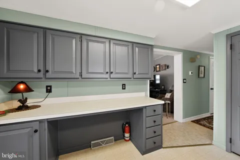 a room with cabinets and white appliances
