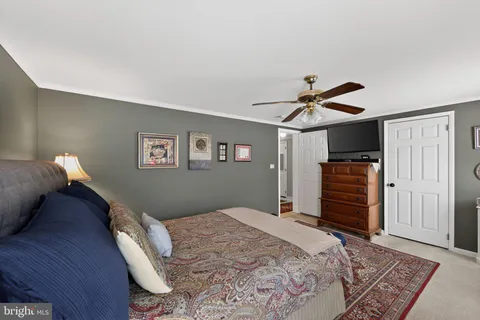 a bedroom with bed and wooden floor