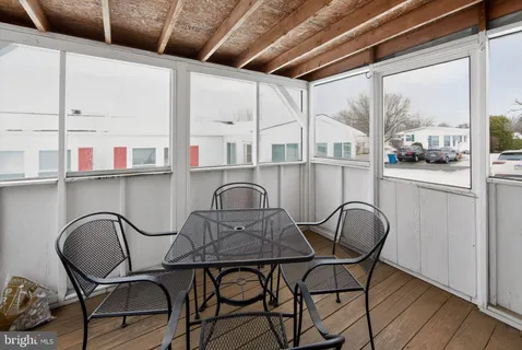 a table and chairs sitting in a kitchen next to a window