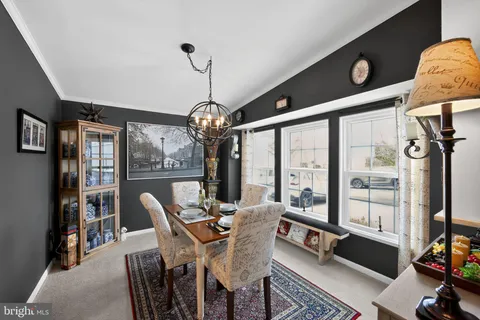 a view of a dining room with furniture large windows and wooden floor