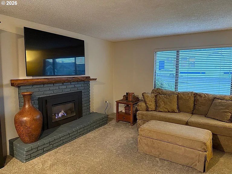 1005 Maple Street Myrtle Point, OR 97458 - Photo 7 of 32 a living room with furniture and a fireplace