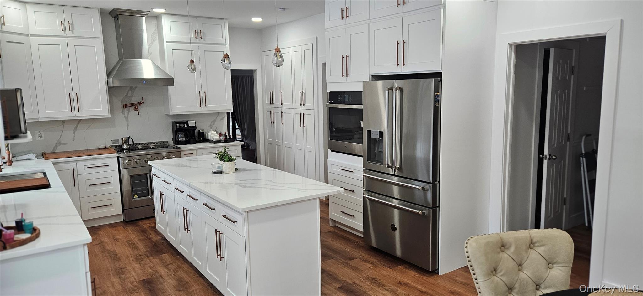 167 Vinegar Hill Road Pine Bush, NY 12566 - Photo 12 of 45 Kitchen featuring premium appliances, white cabinetry, dark wood-style floors, a center island, and recessed lighting