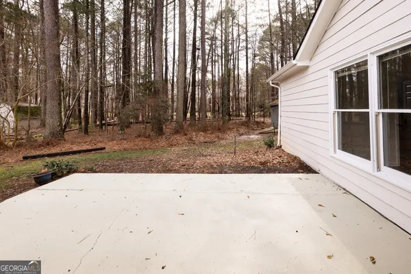 a view of a white house with a yard and garage