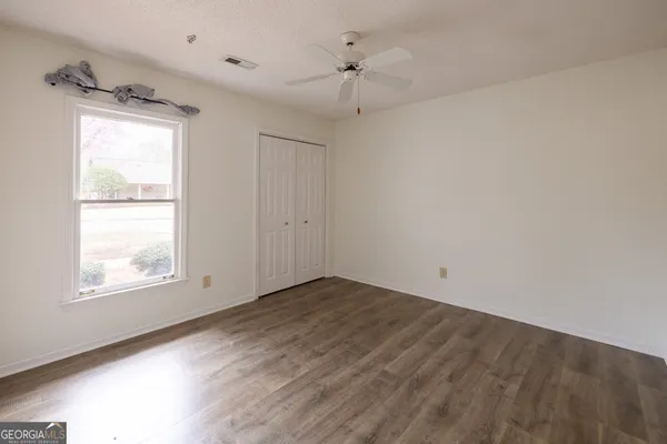 a bedroom with a bed and a mirror