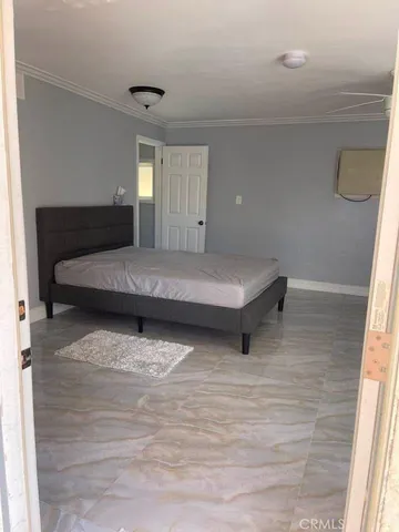 a living room with a bed furniture and a window
