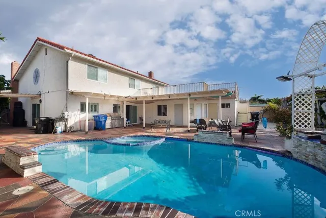 a view of a house with swimming pool and sitting area