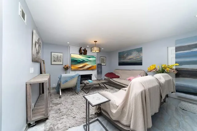 a bedroom with furniture and a flat screen tv