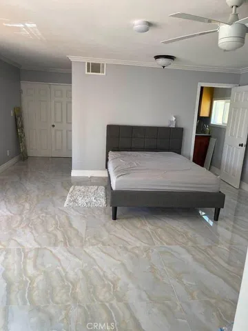 a bedroom with a bed and window