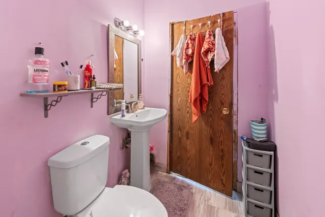 a bathroom with a toilet sink and shower curtain