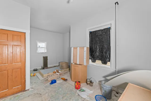 a bedroom with furniture and a window