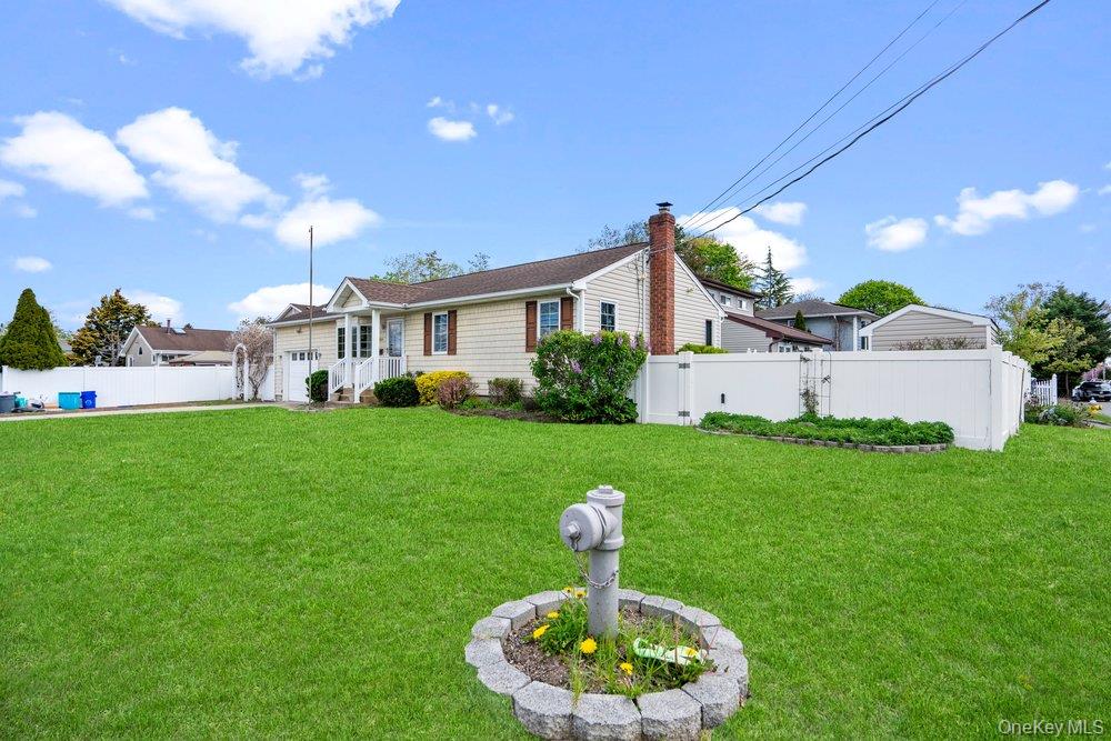 101 Sexton Road West Babylon, NY 11704 - Photo 2 of 33 a front view of a house with a yard fire pit and outdoor seating