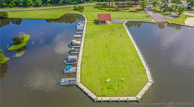 an aerial view of a house with swimming pool and garden space