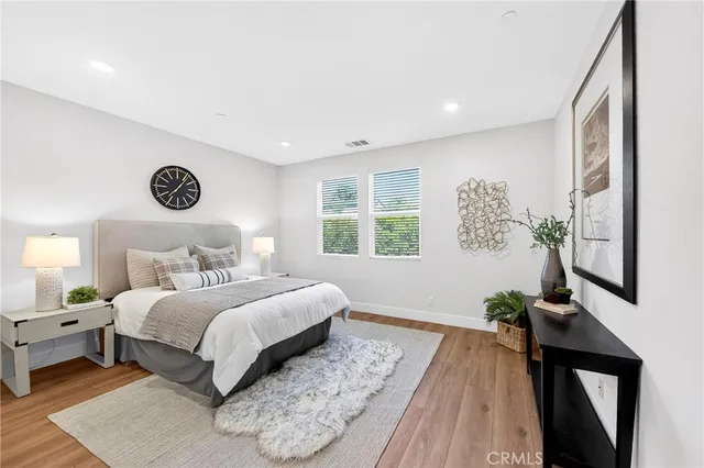 a bedroom with a bed and a potted plant