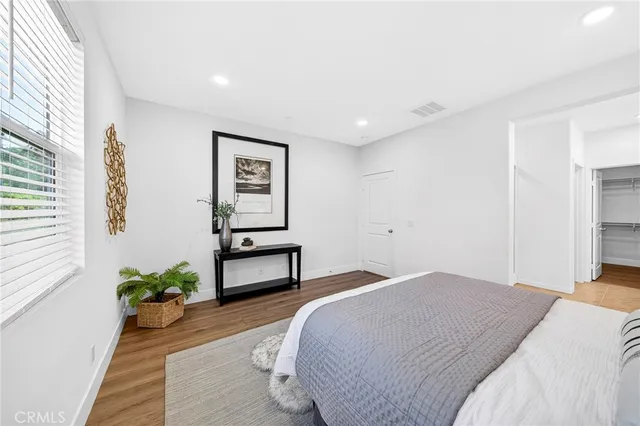 a en suite spacious bathroom with a tub double vanity sink and glass door