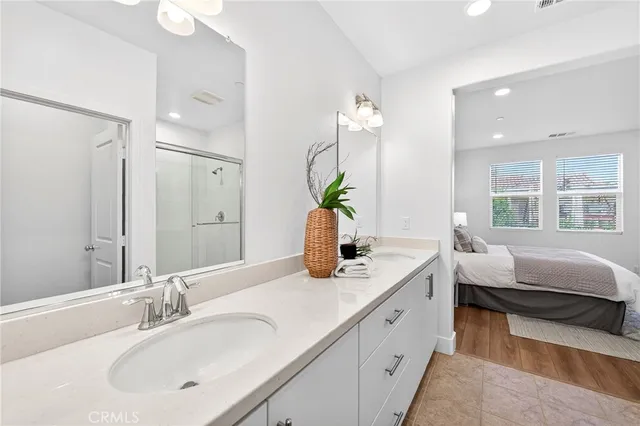 a bathroom with a double vanity sink and a mirror