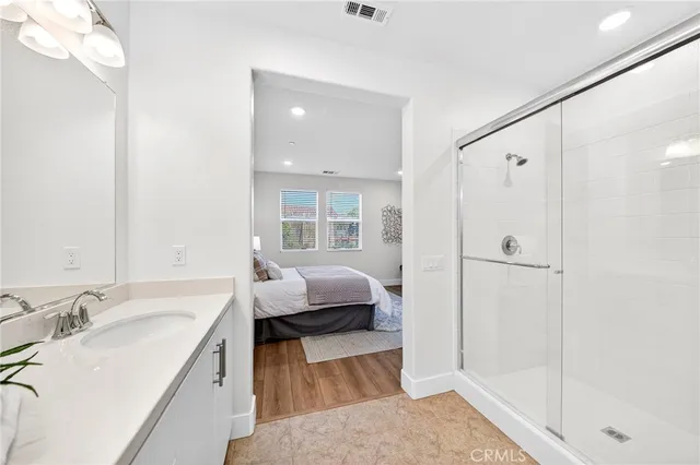 a bathroom with a shower and a glass door