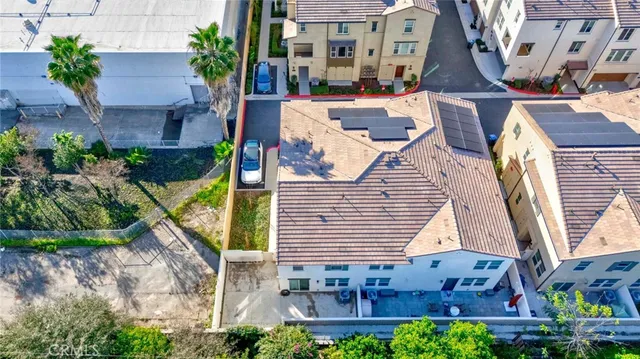 a living room with furniture kitchen view and a wooden floor