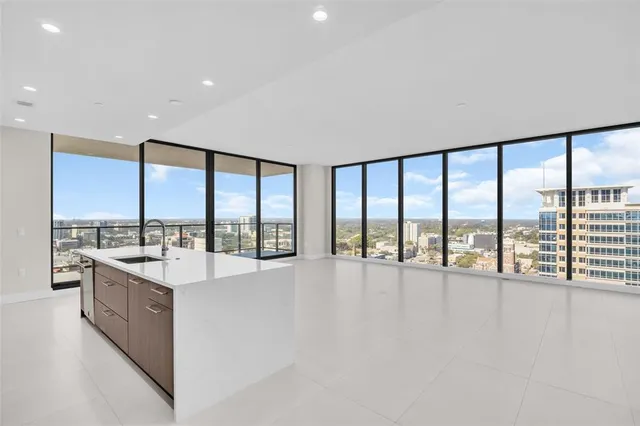 a kitchen with stainless steel appliances granite countertop a sink and a refrigerator