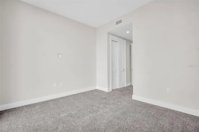 a view of a patio with chairs and potted plants
