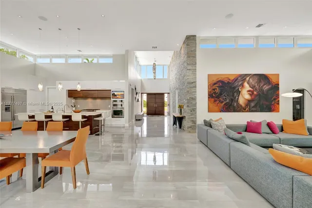 a dining hall with stainless steel appliances lots of white furniture a window and a view of dining hall with wooden floor