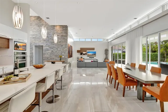 a kitchen with a stove a table and chairs in it