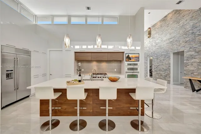 a kitchen with appliances cabinets and a counter top space