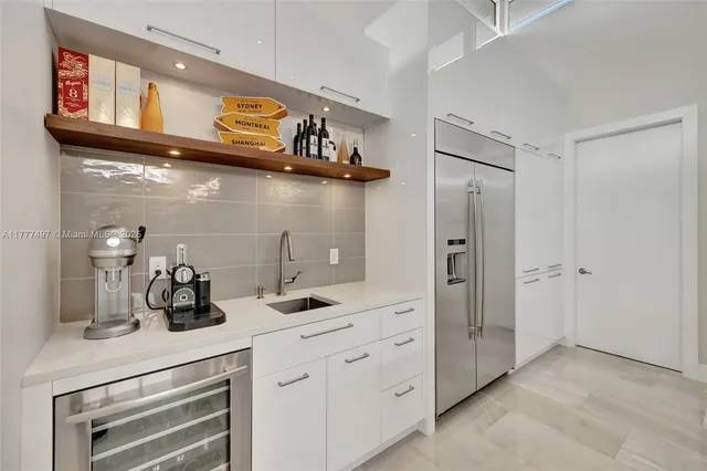 a kitchen with stainless steel appliances a sink a stove and a wooden floors