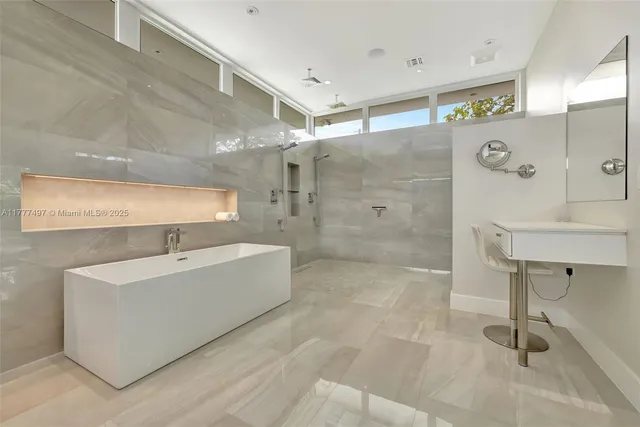 a bathroom with a tub a sink and mirrors