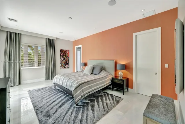 a bathroom with a granite countertop sink a toilet and a large mirror