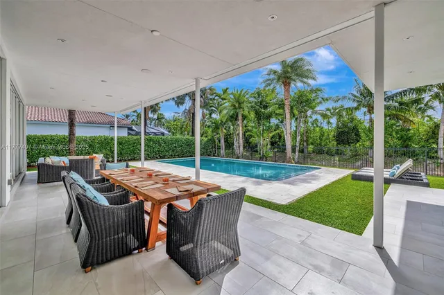 a view of a house with a yard patio and swimming pool