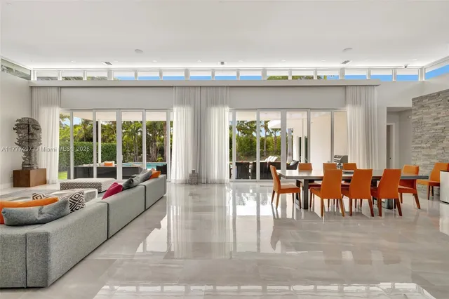 a living room with furniture garden view and a large window