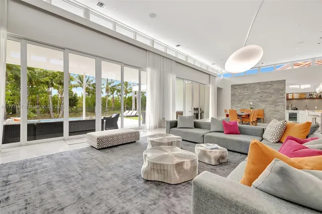 a living room with furniture a dining table and chairs