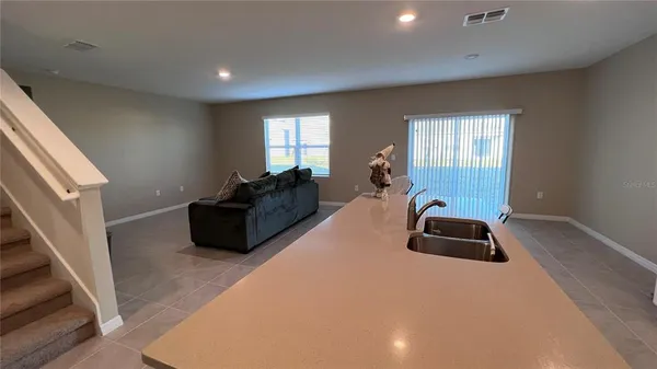 a living room with furniture a couch and a window